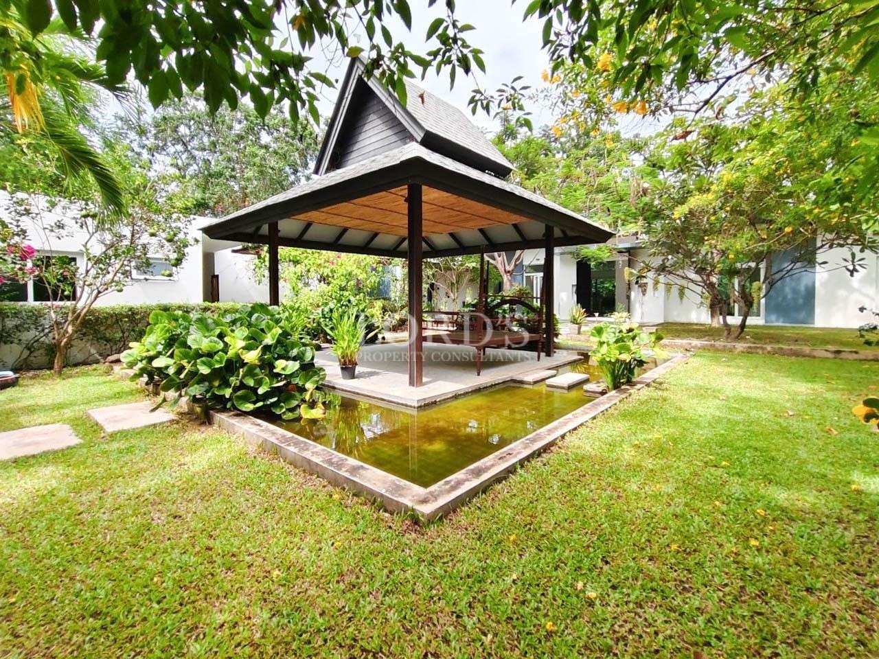Garden pavilion with seating and greenery