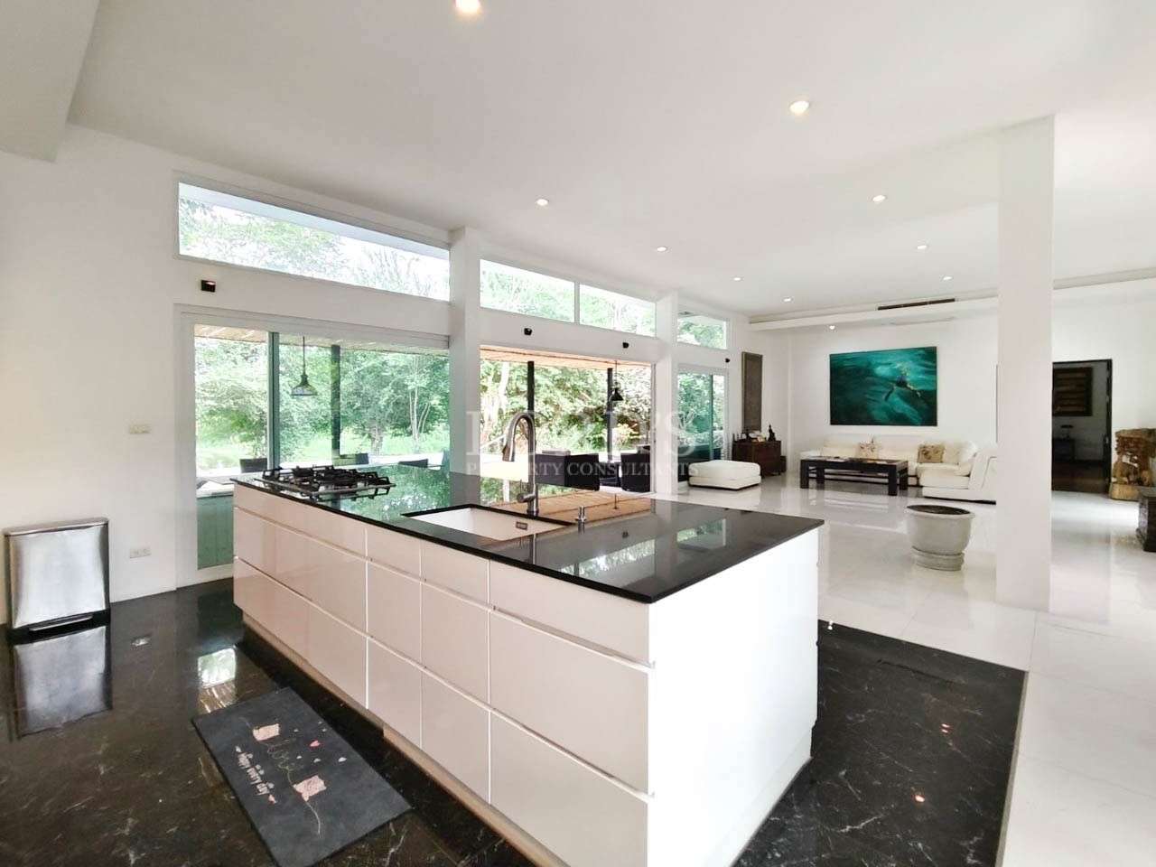 Kitchen with white cabinets and black countertop