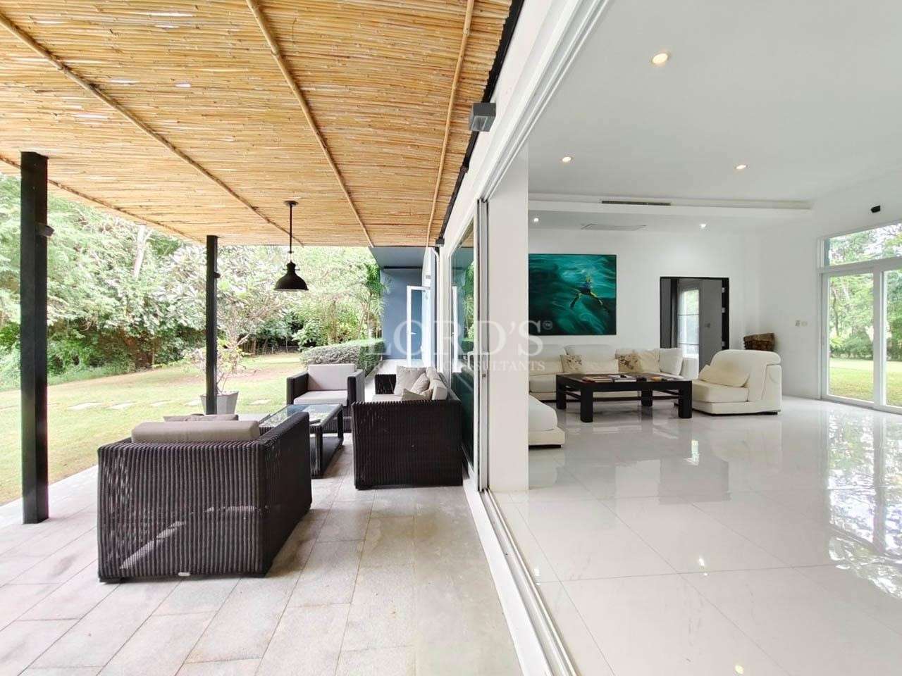 Covered terrace with seating and garden view