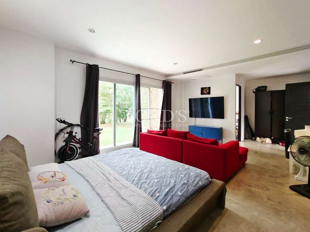Bedroom with large windows and sofa