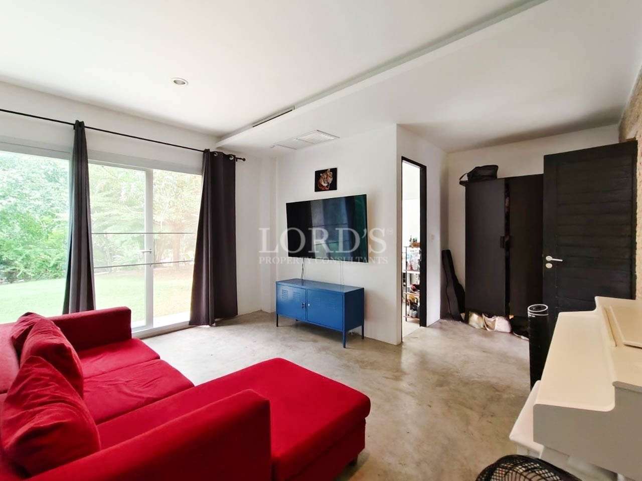 Living area with red sofa and TV
