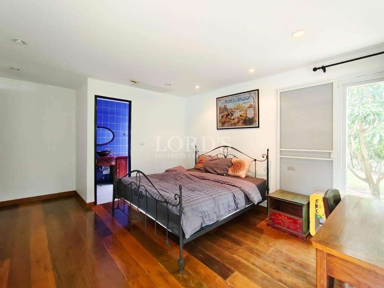 Bedroom with wooden floor and large bed