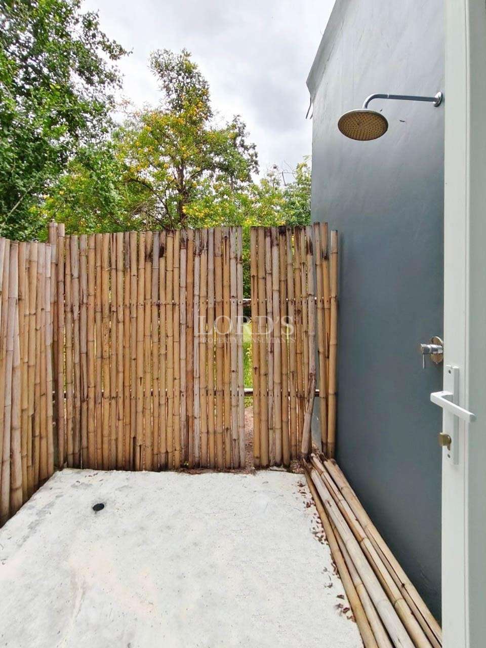 Outdoor shower with bamboo fence