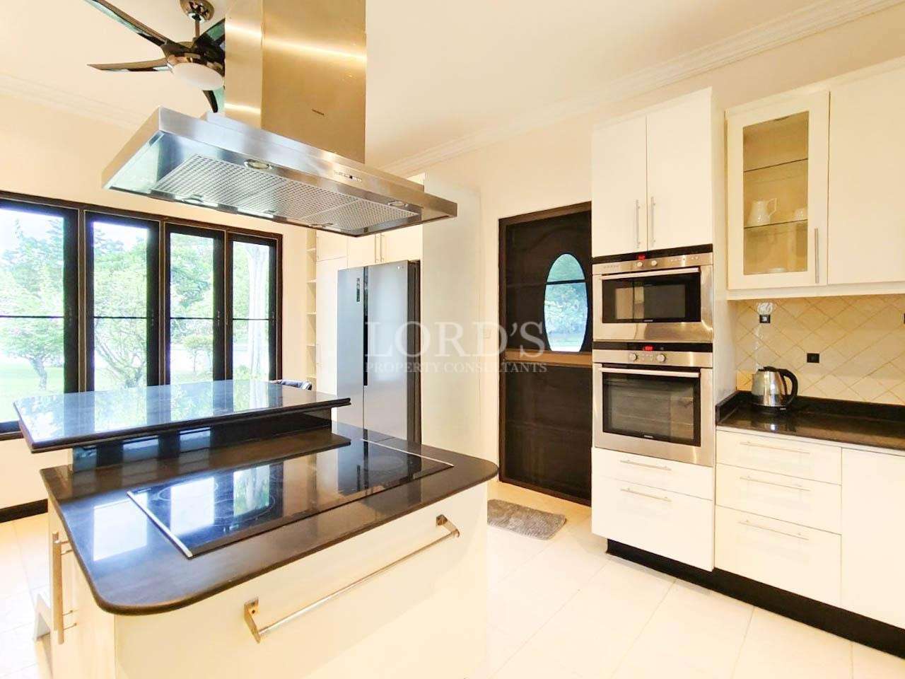 Modern luxury kitchen with black granite island and built-in oven
