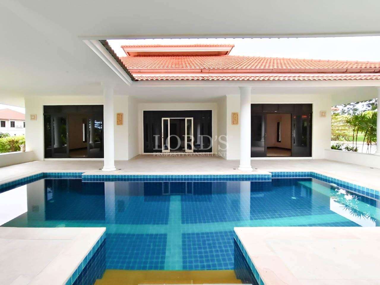 Luxury villa with covered patio, white columns, and large private swimming pool
