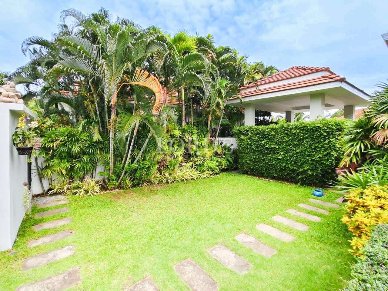 Garden with palm trees and stepping stones