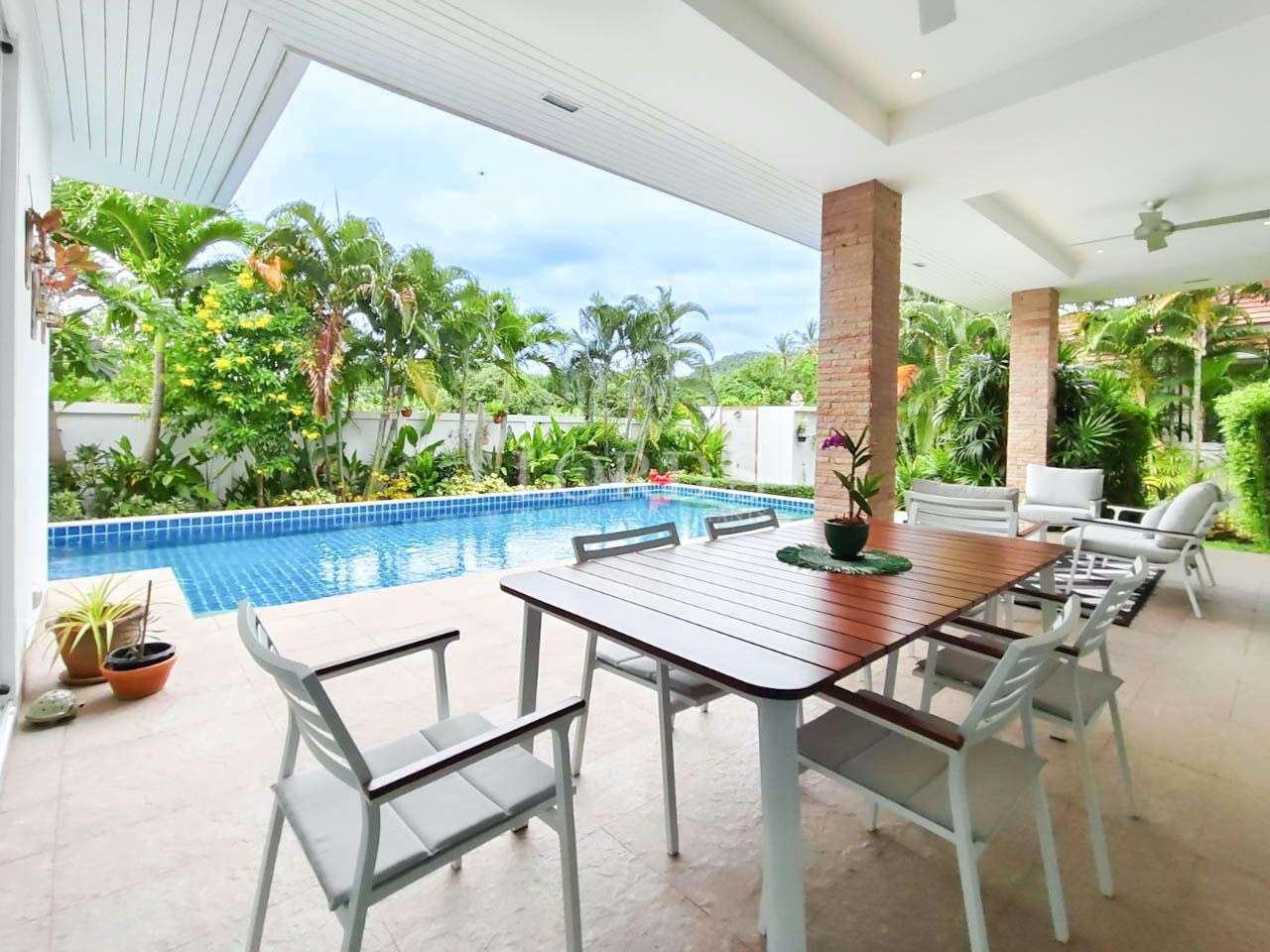 Outdoor patio dining with pool view