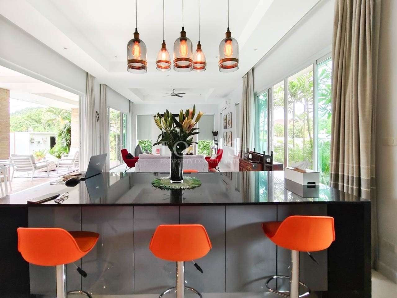 Dining table with orange chairs and decor