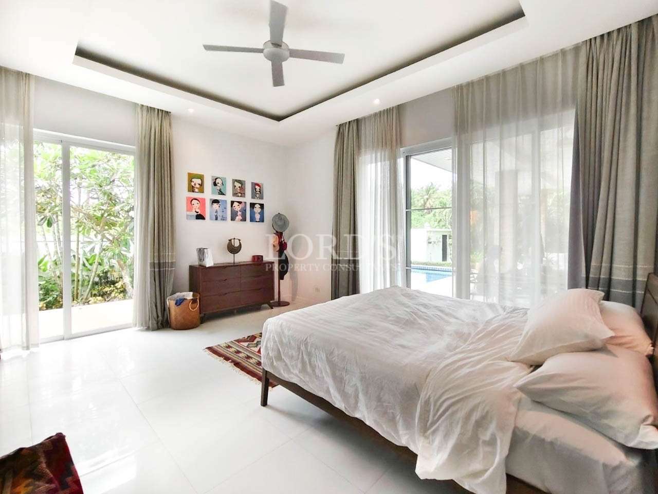 Bedroom with bed and large windows