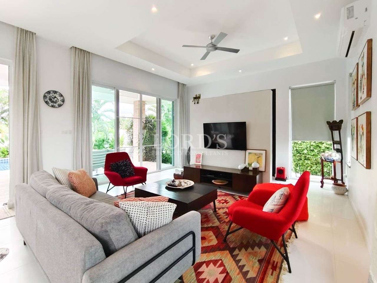 Living room with sofa and red chairs