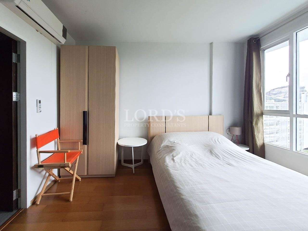 Bedroom with bed and wooden flooring