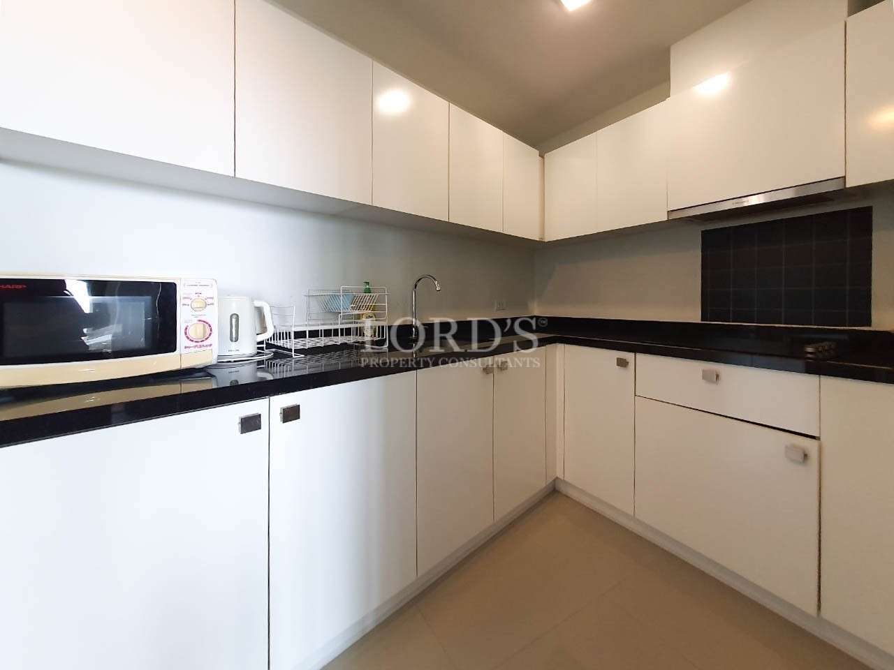 Kitchen with L-shaped counter and cabinets