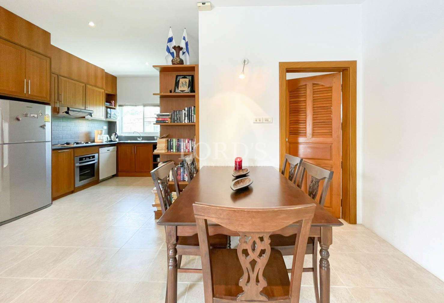 Dining area with wooden table near kitchen