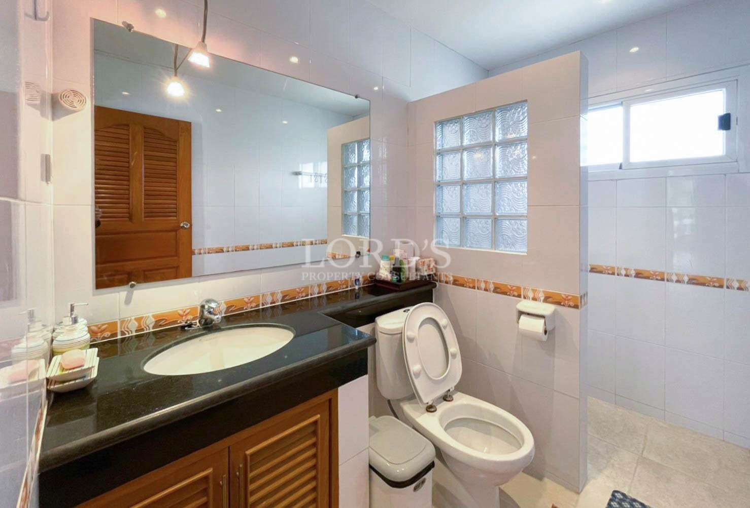 Bathroom with sink, mirror, and toilet