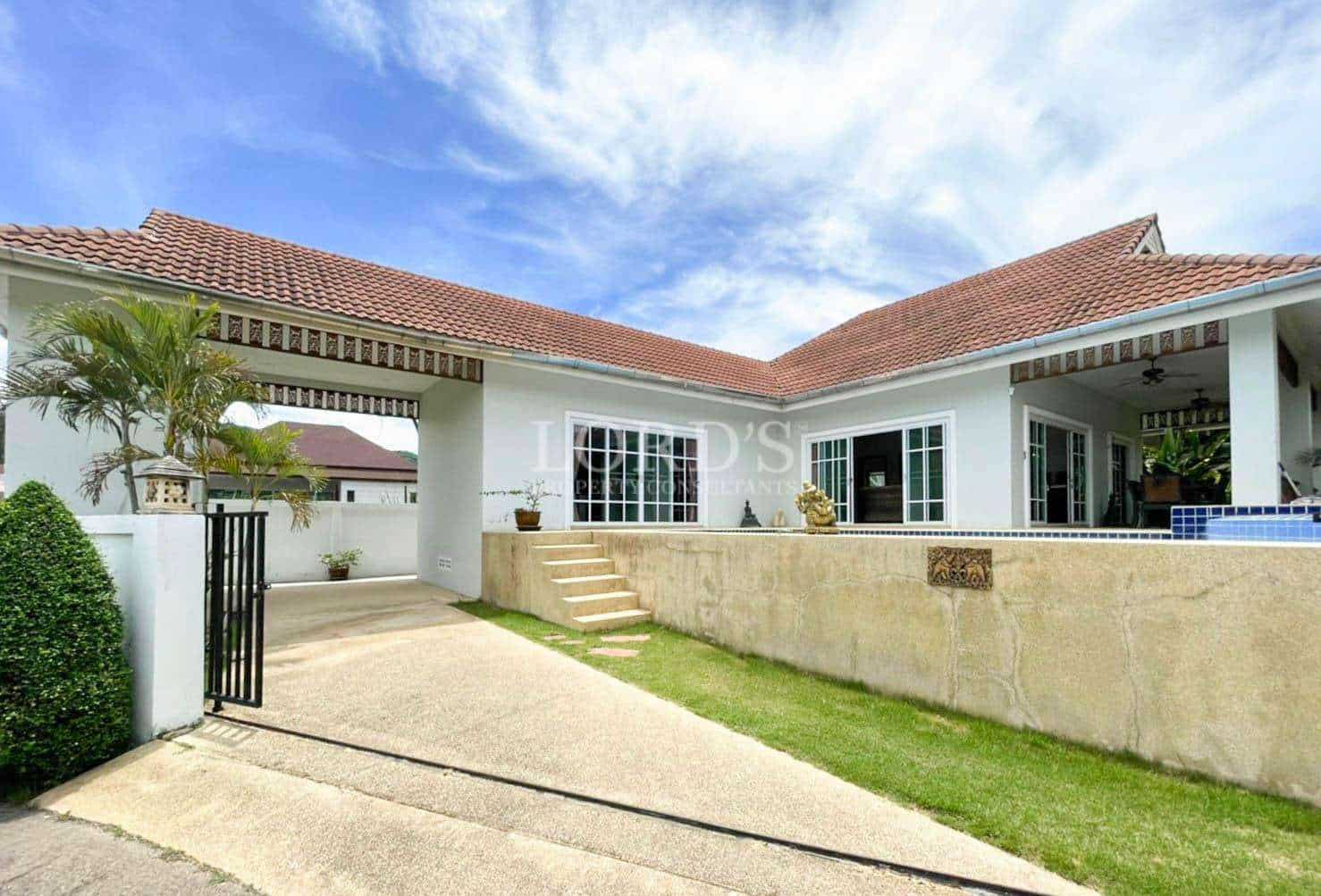 House exterior with courtyard and grass area