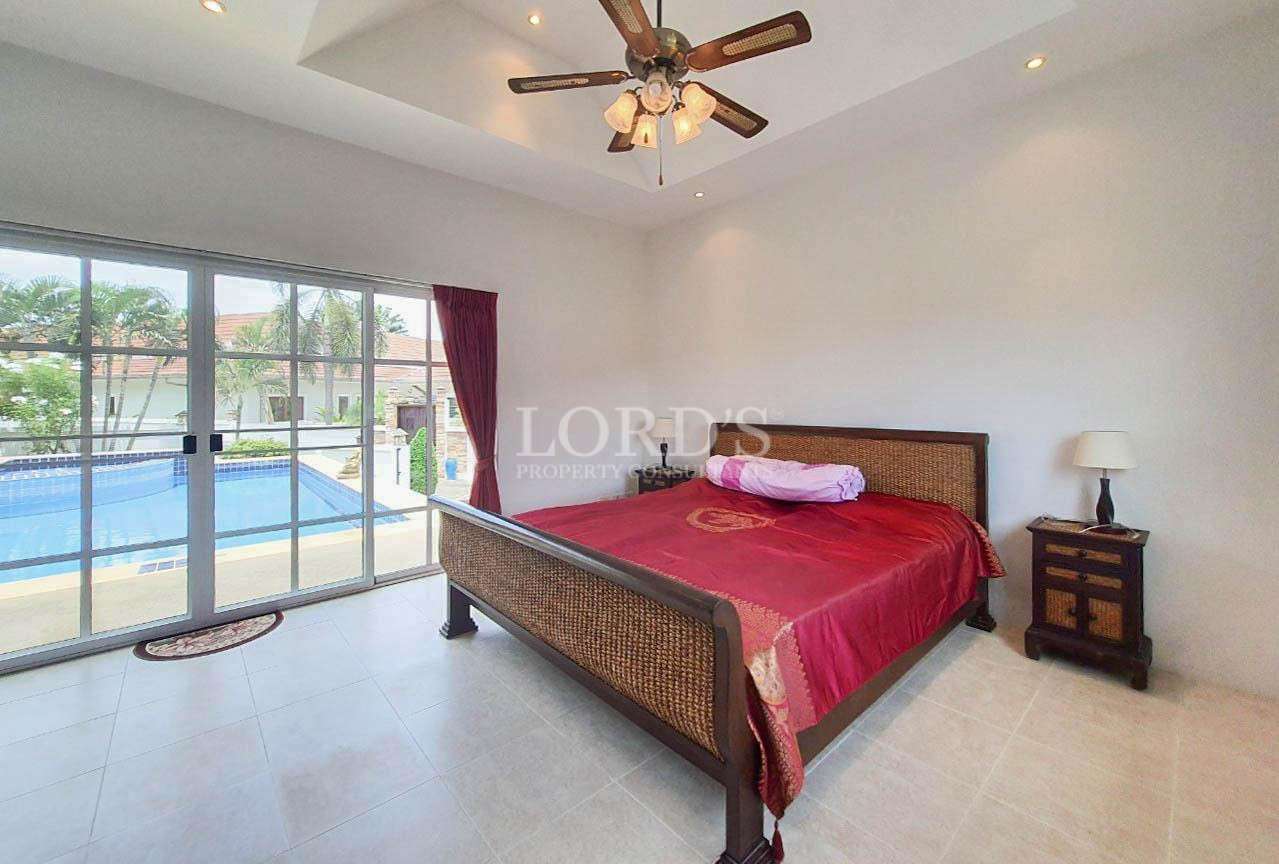 Modern bedroom with red bedding and decor