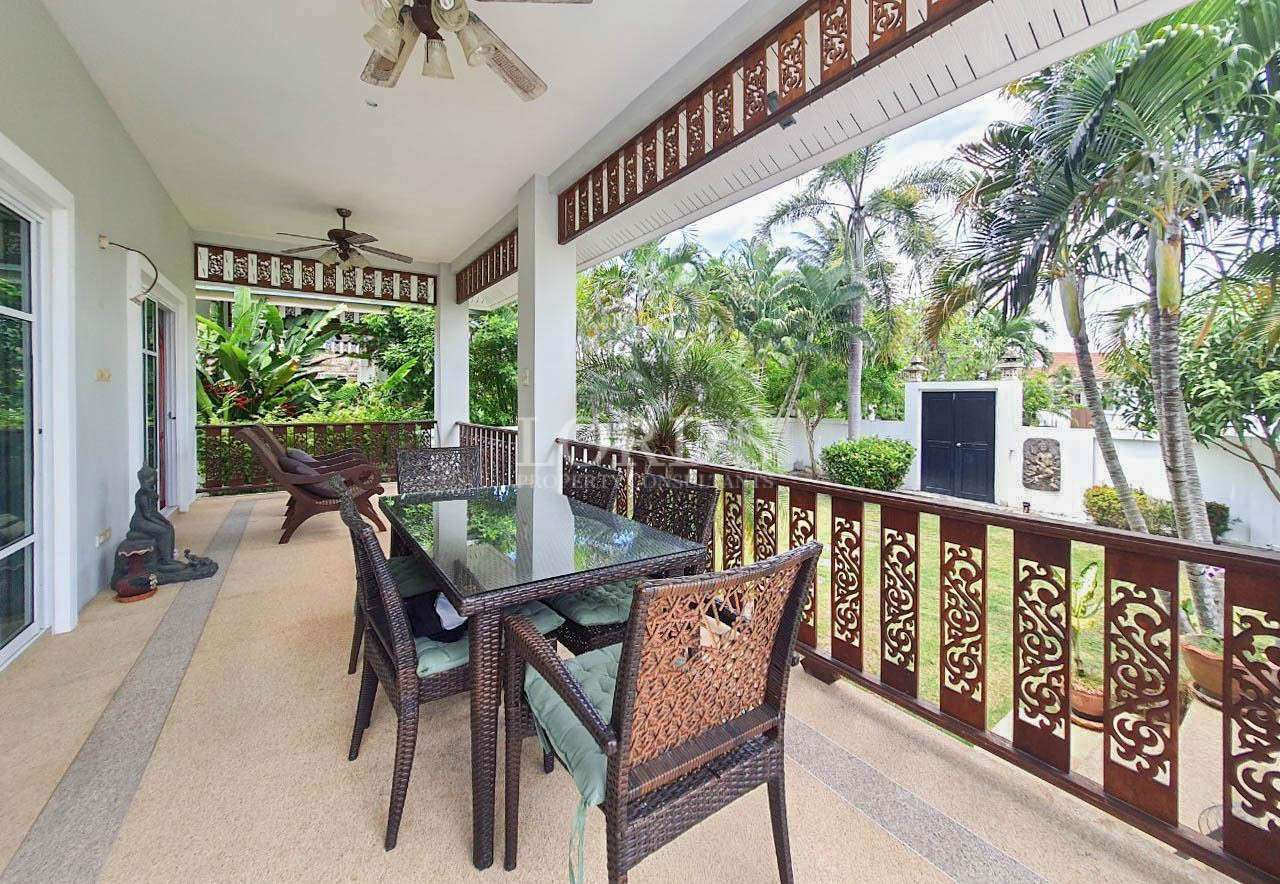 Balcony with table, chairs, and garden view