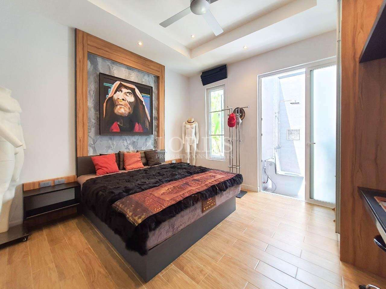 Bedroom with bed and large artwork above headboard