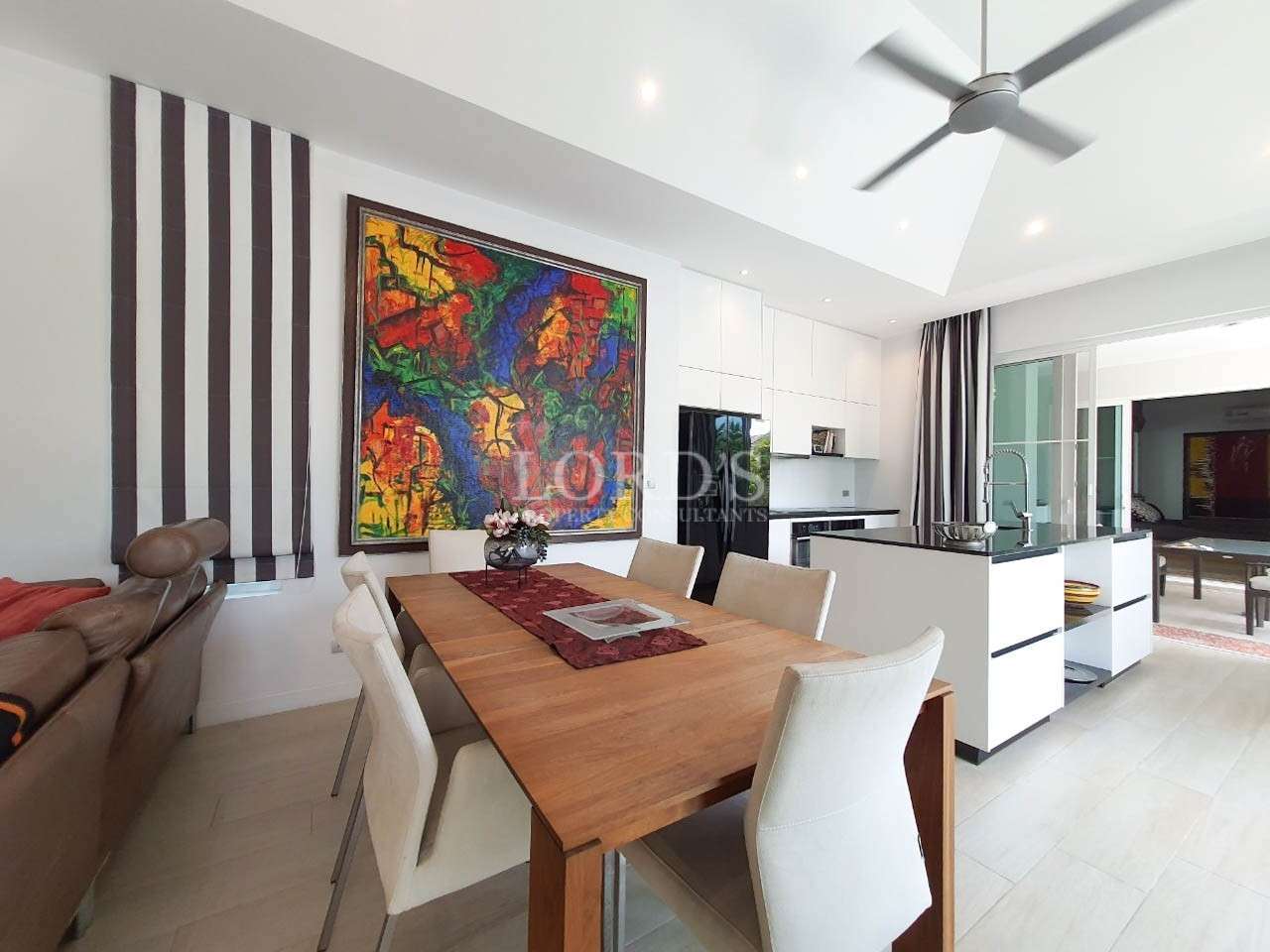 Dining area with table and colorful artwork
