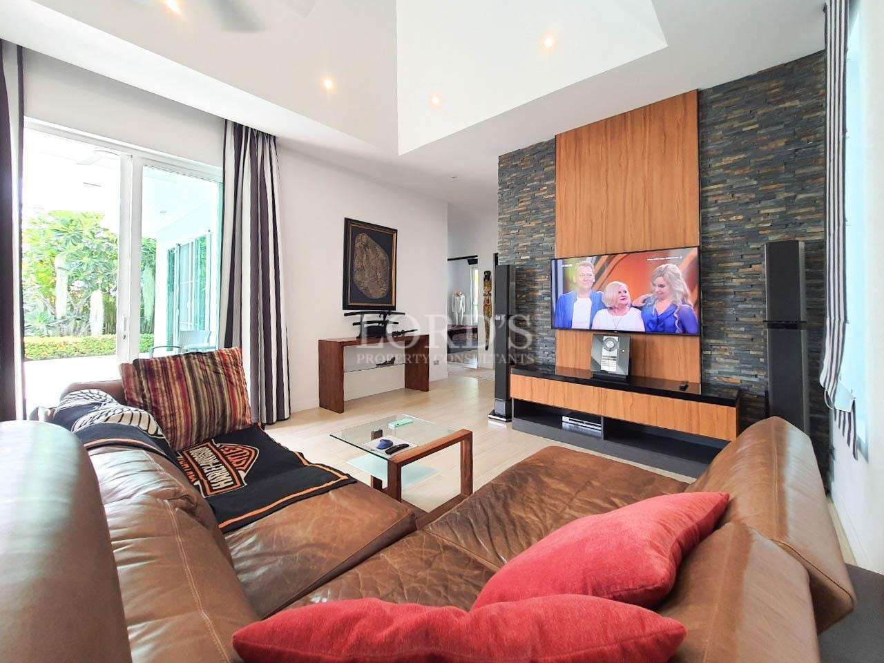 Living area with red sofa and TV unit