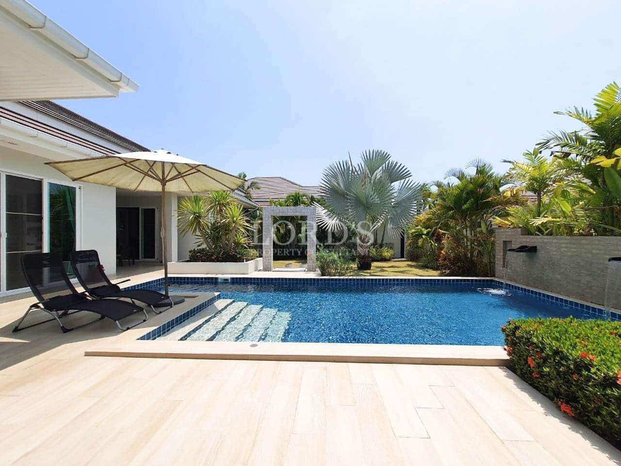 Swimming pool with villa and patio