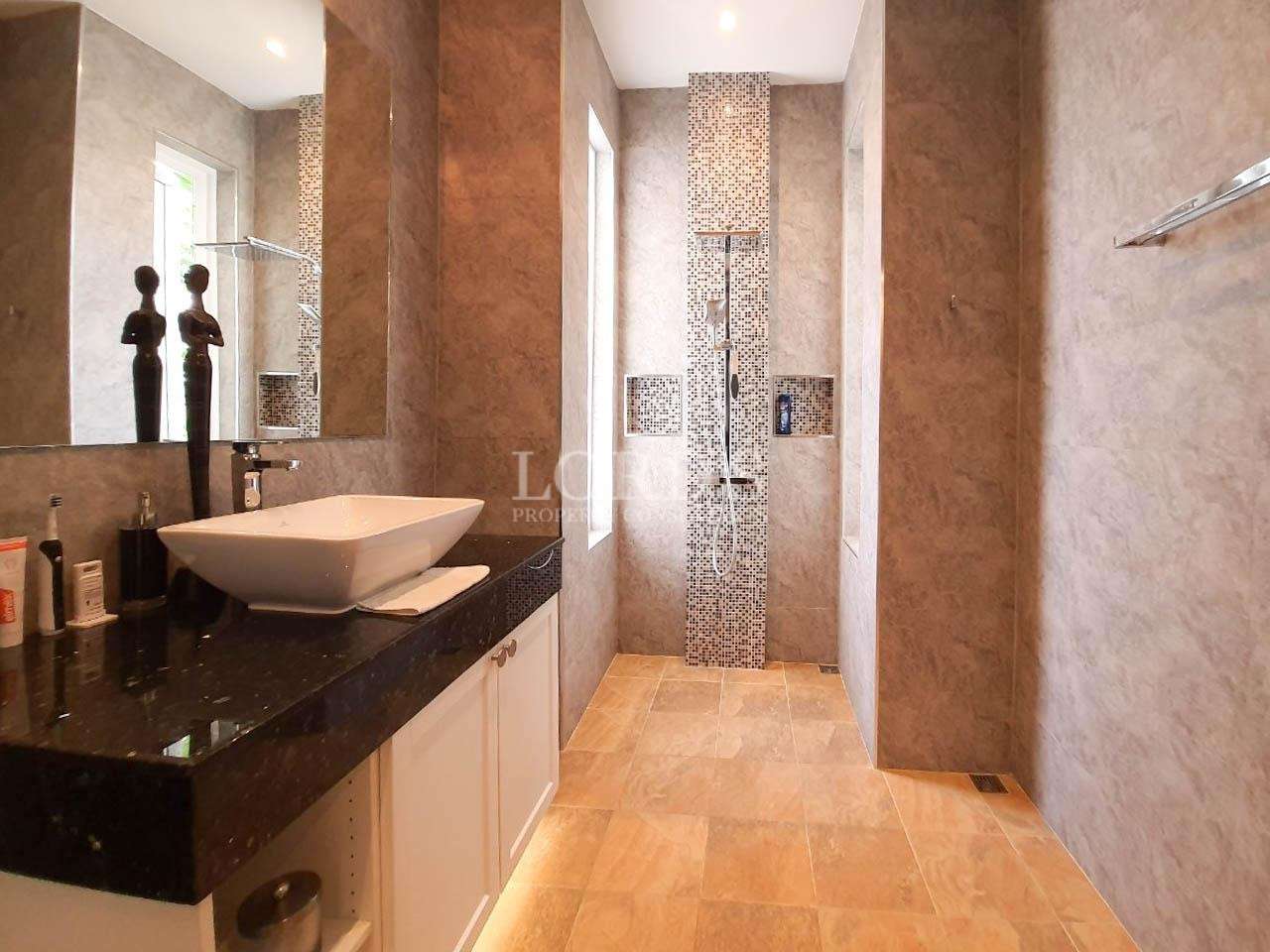 Bathroom with double vanity and shower