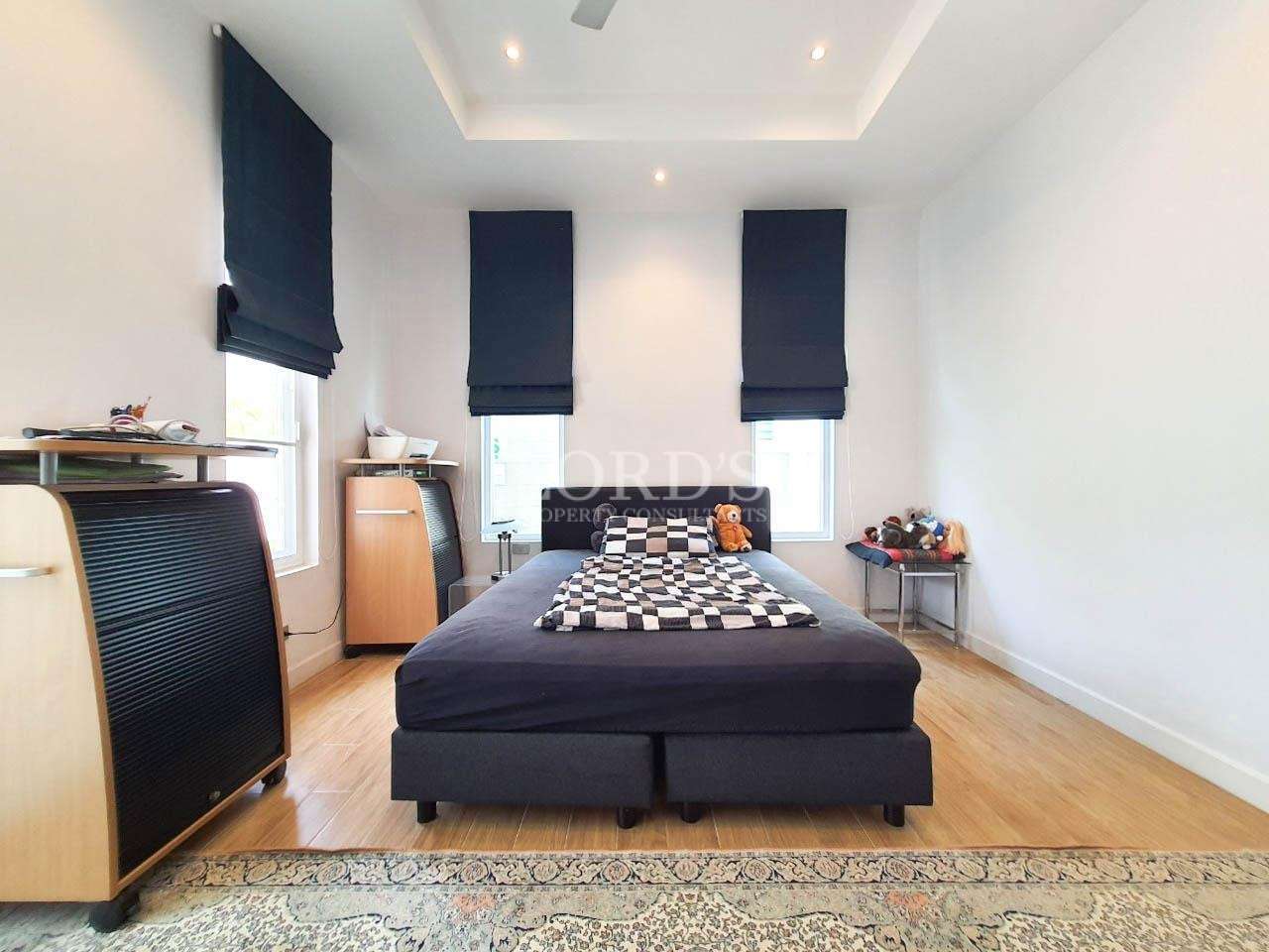 Bedroom with bed and dark curtains