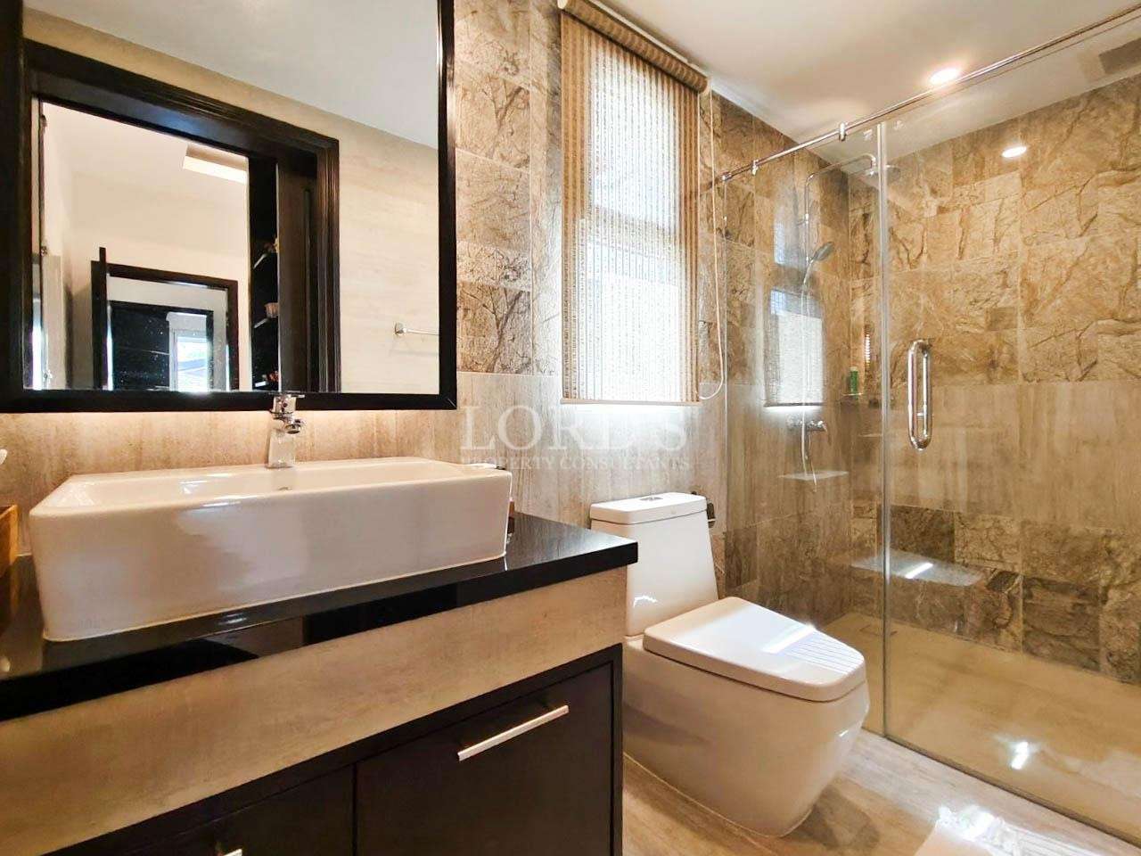 Bathroom with vanity sink and marble wall tiles