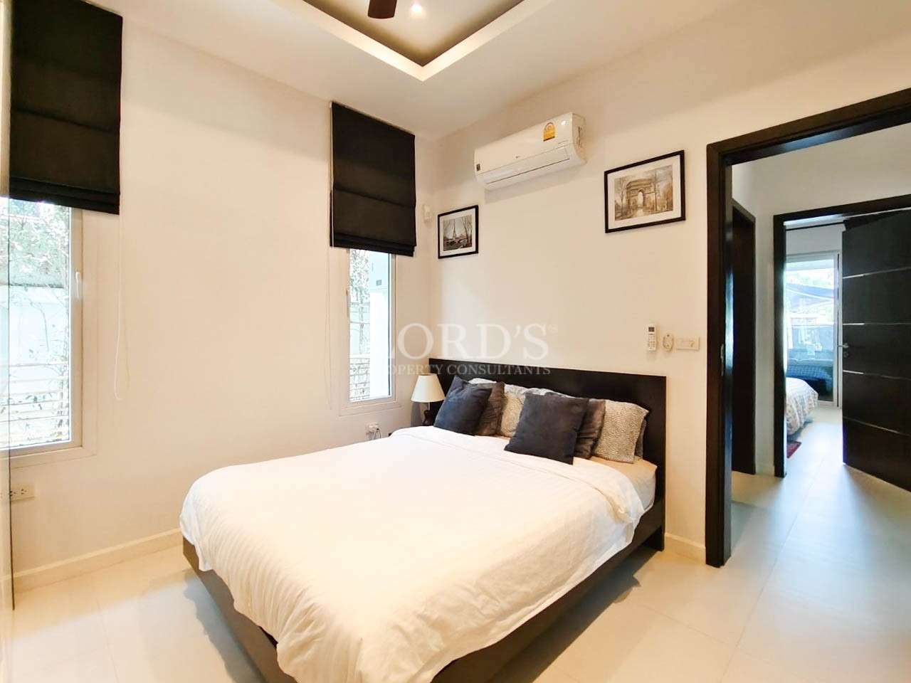 Minimalist bedroom with double bed and wall decor