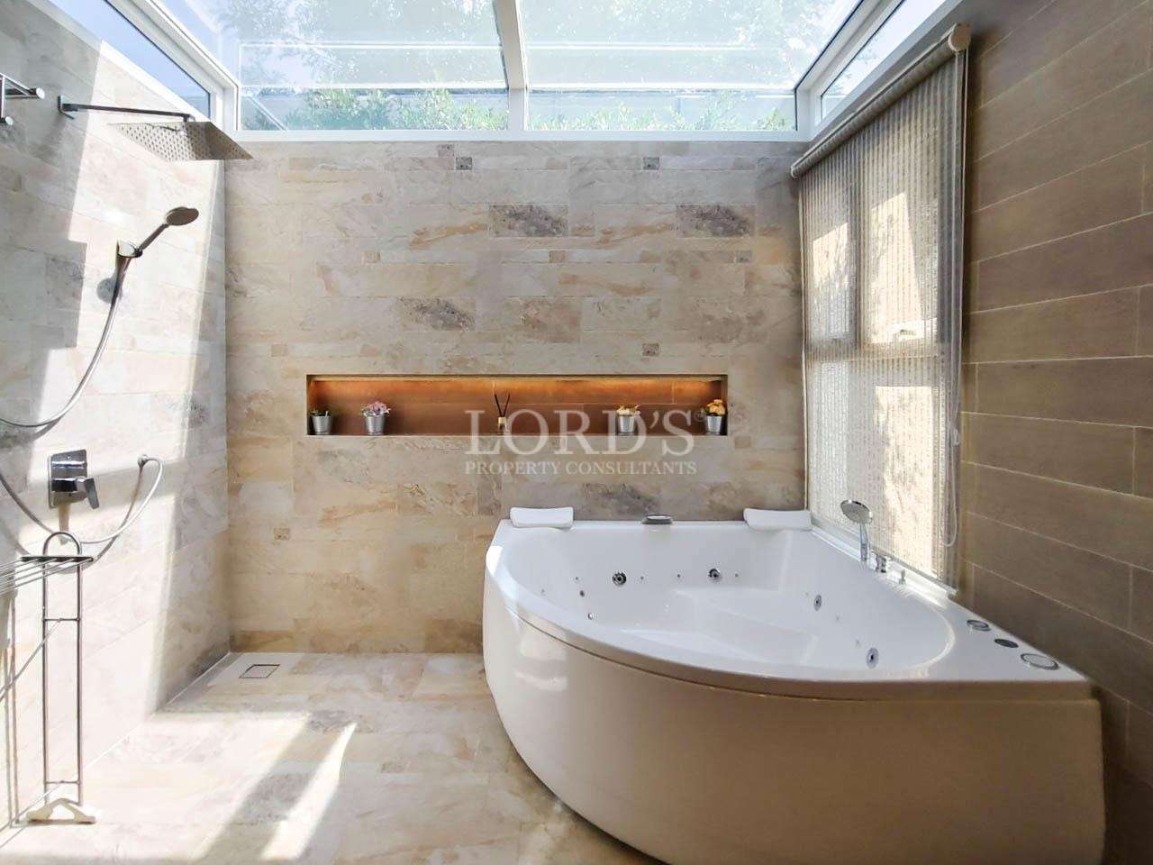 Bathroom with freestanding bathtub and window