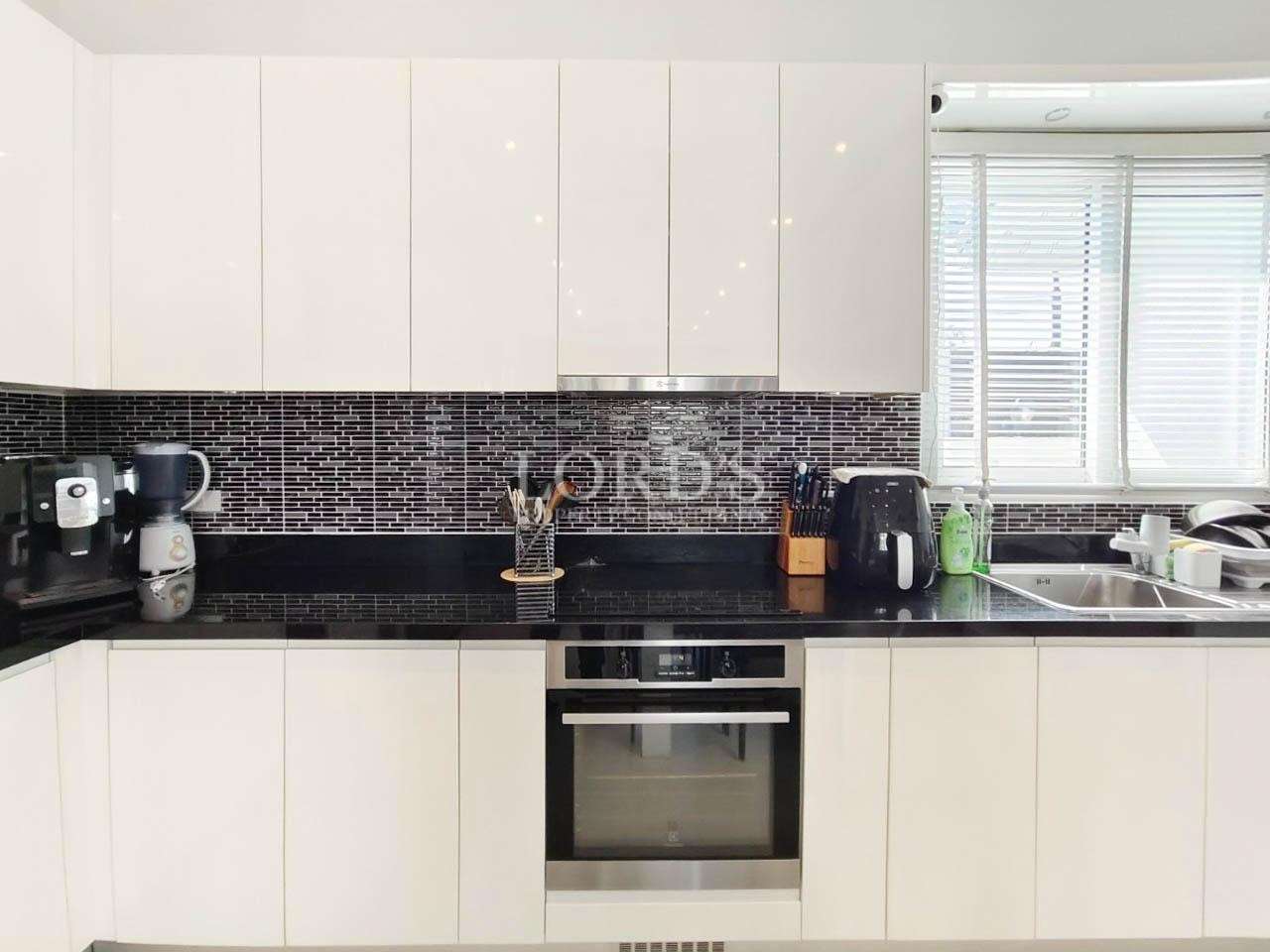 Kitchen with black countertop and modern cabinets