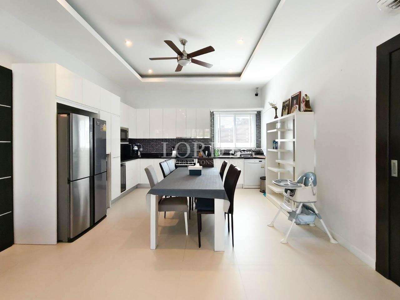 Dining room with long table and modern lighting
