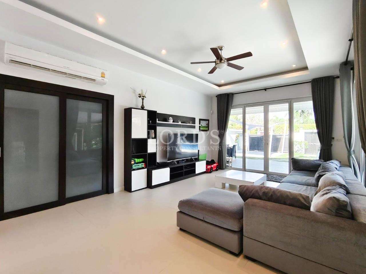 Open living room with TV unit and seating