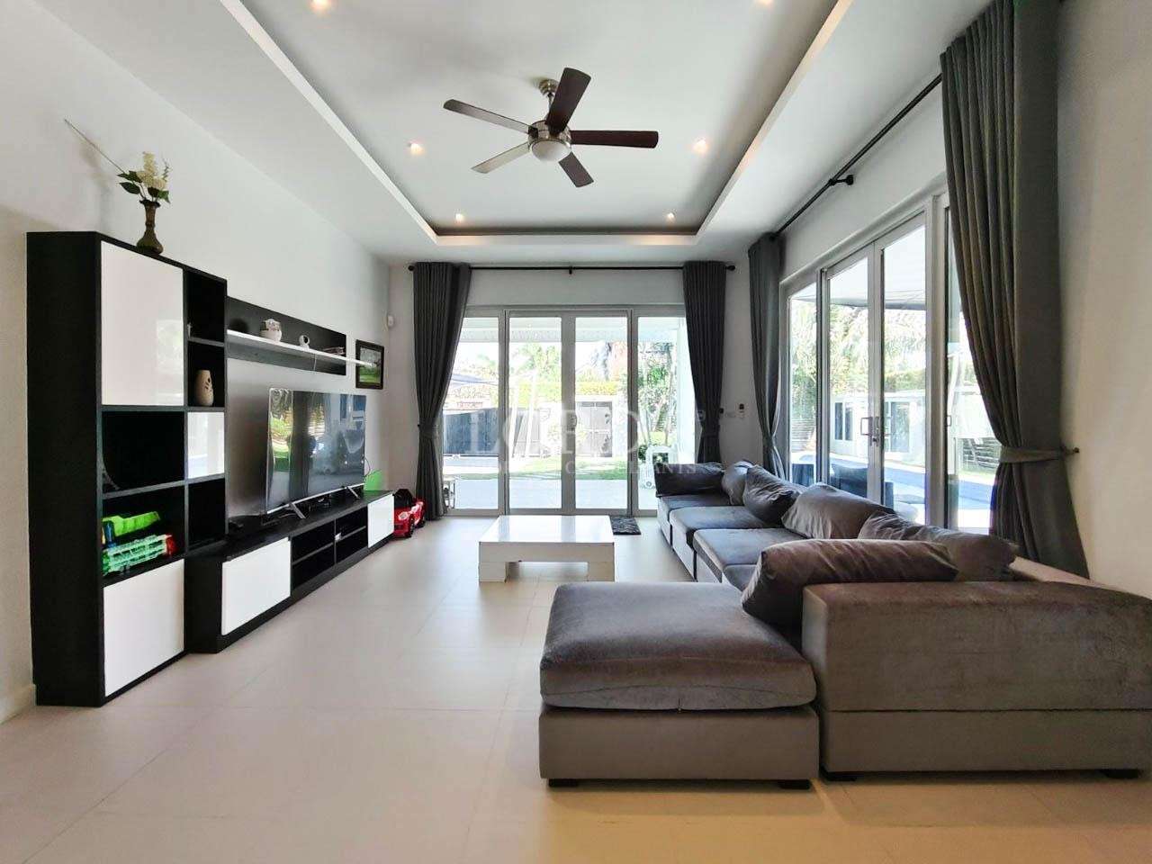 Modern living room with sectional sofa and large windows