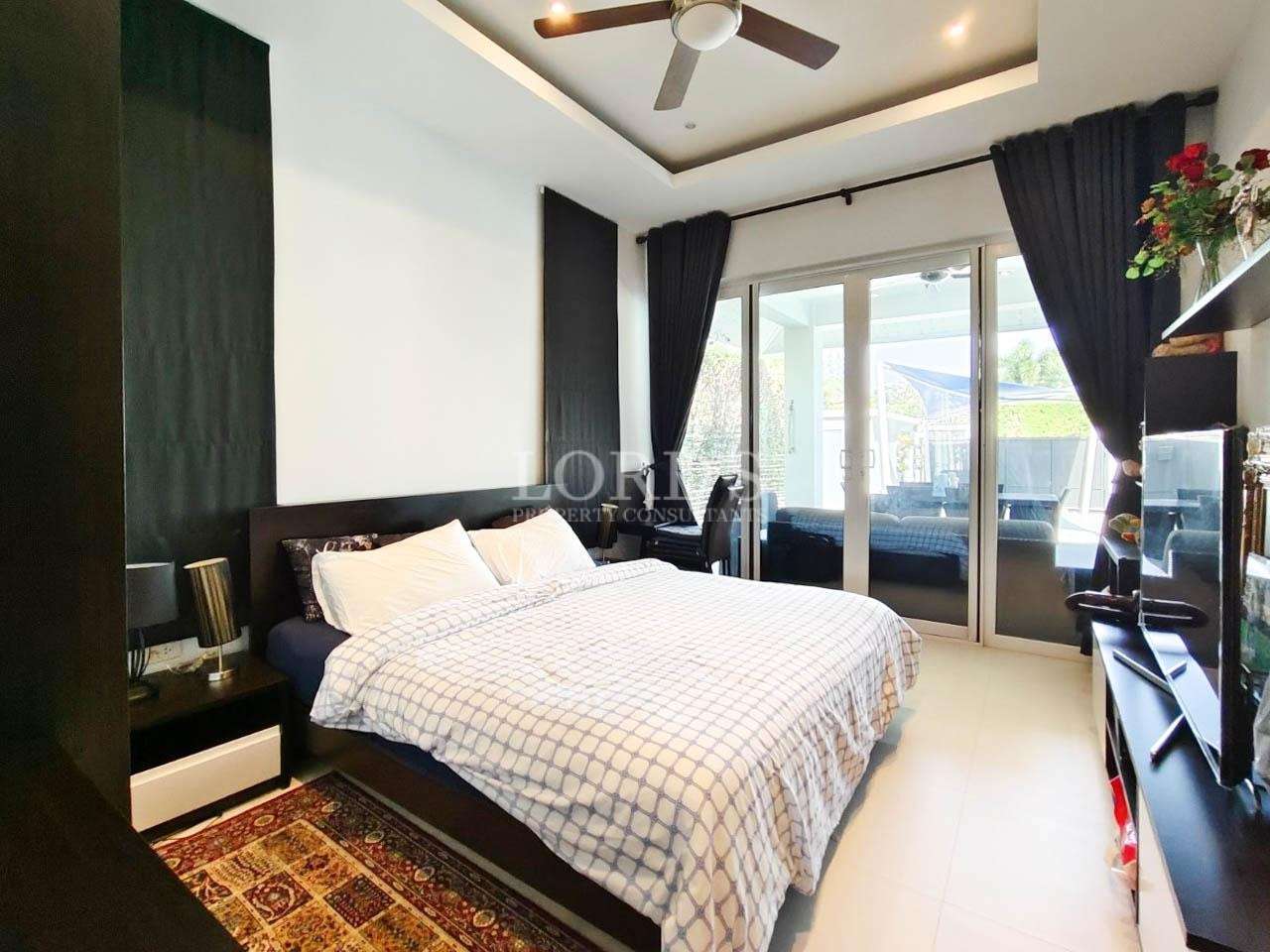 Bedroom with large windows and modern decor
