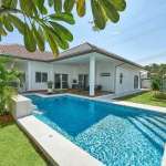 Poolside garden view with villa