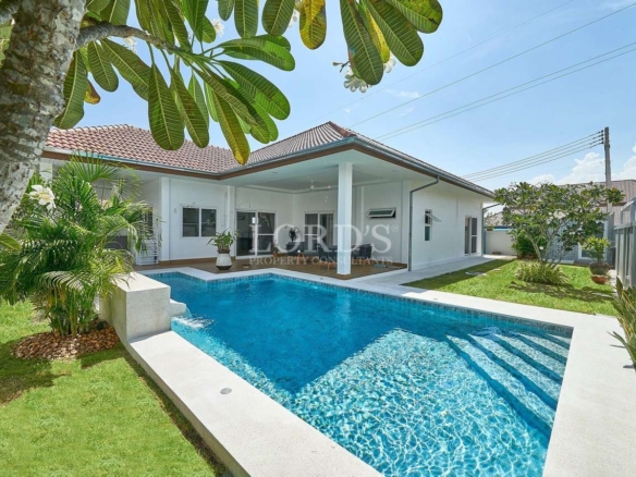 Poolside garden view with villa