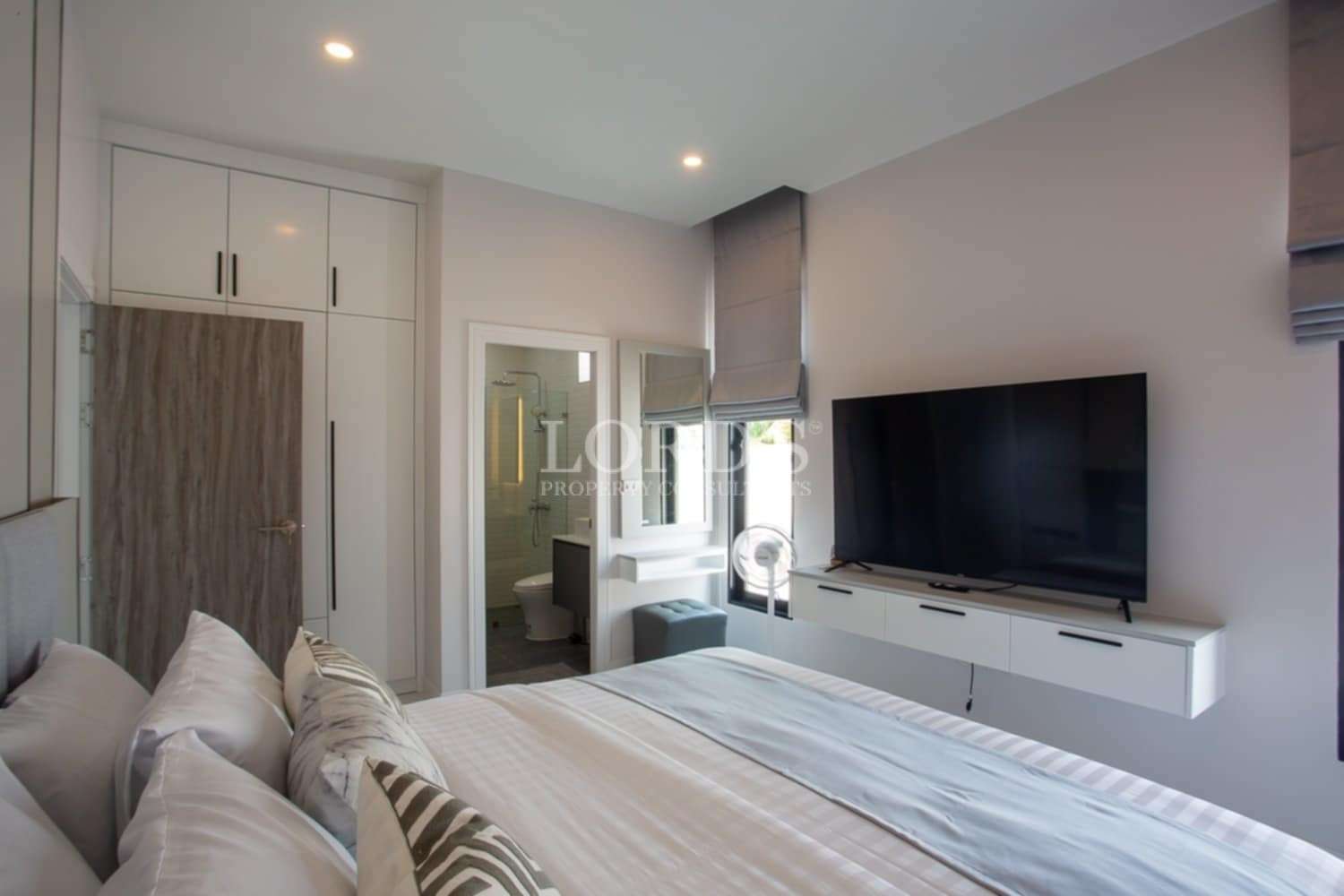 Beautiful bedroom with TV and soft decor