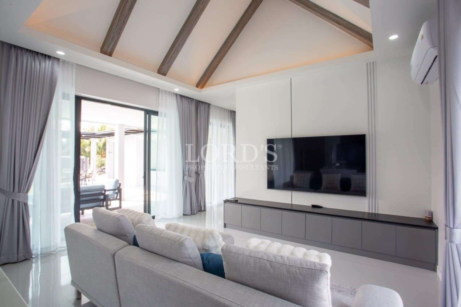 Beautiful living room with TV wall and wooden ceiling