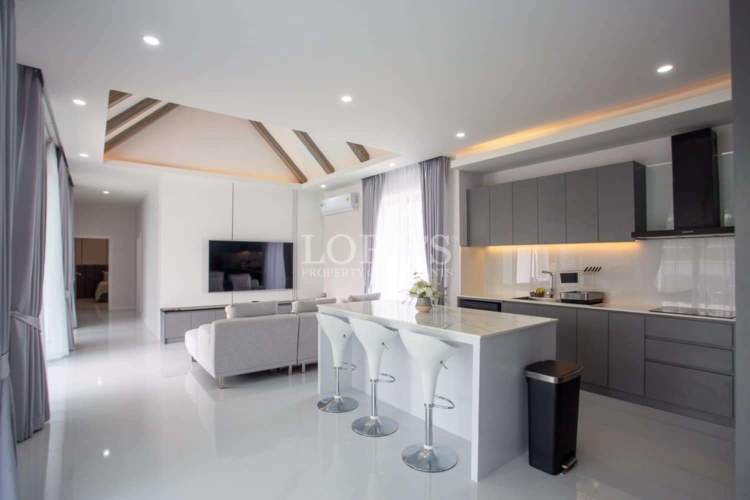Beautiful modern kitchen with island and bar stools