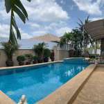 Poolside with palm trees and clear blue water