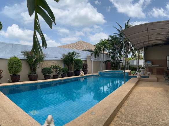 Poolside with palm trees and clear blue water