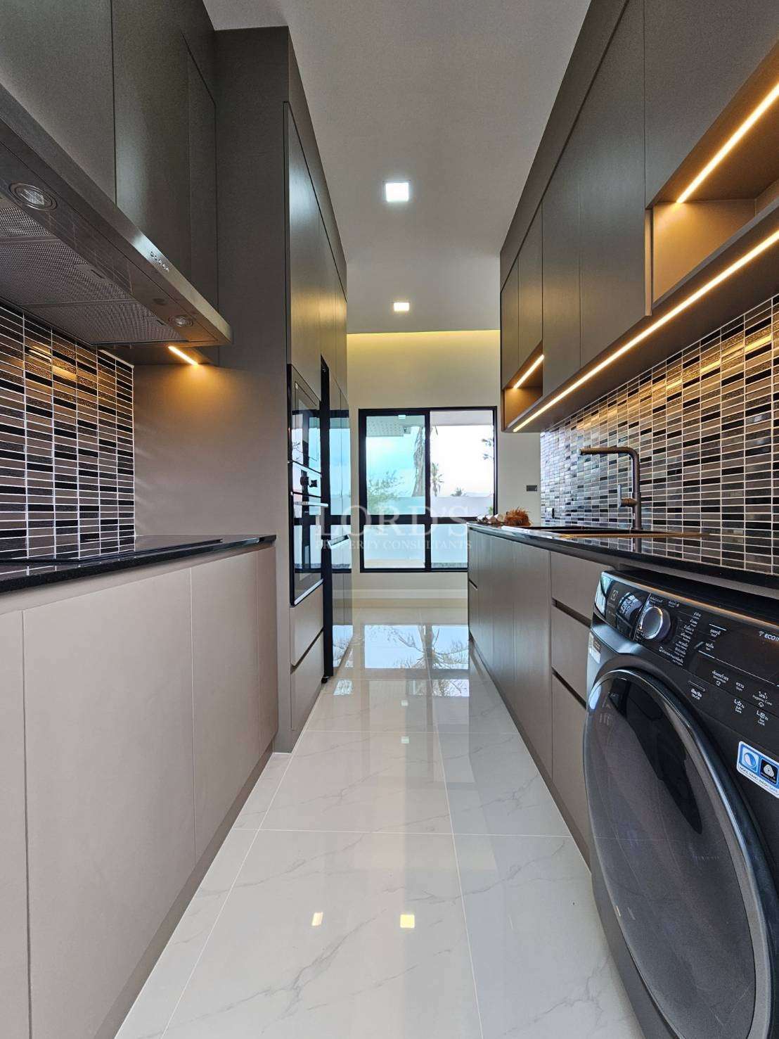 Kitchen corridor with cabinets and lighting