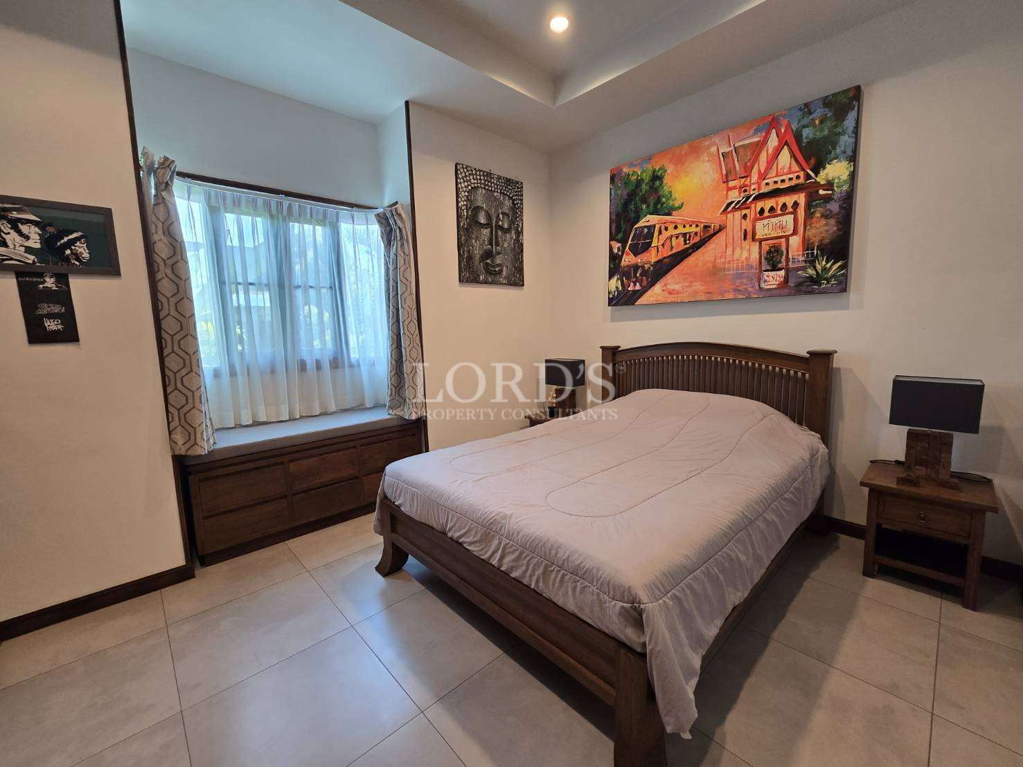 Bedroom with bed and framed artwork