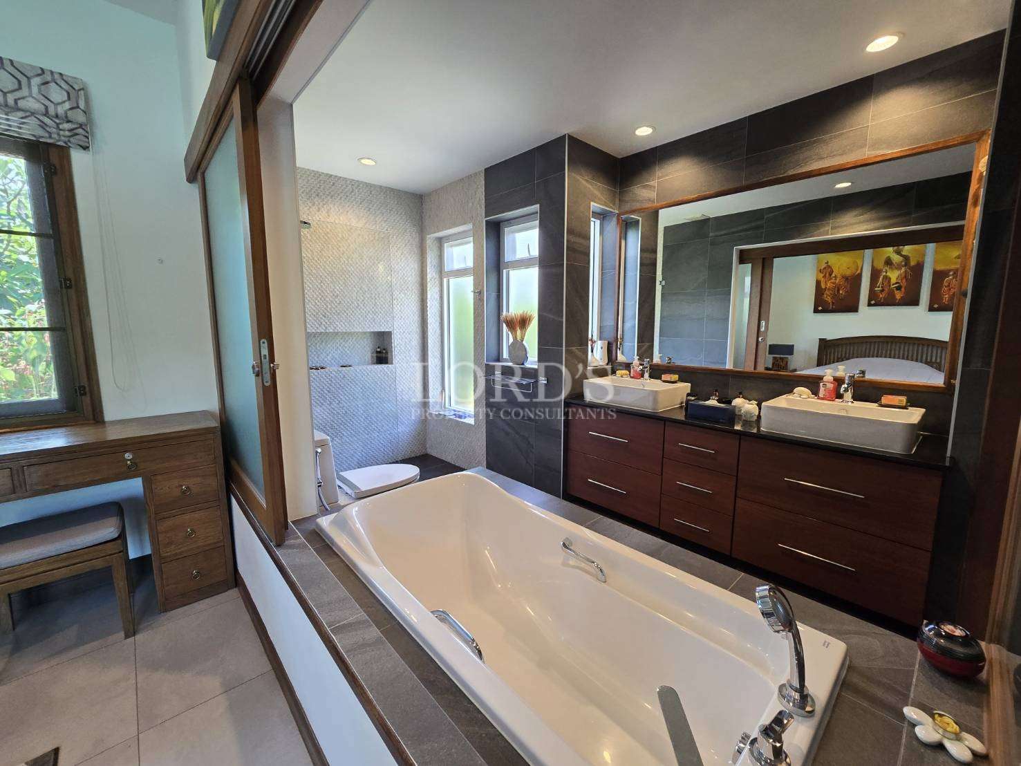 Bathroom with bathtub and wooden vanity