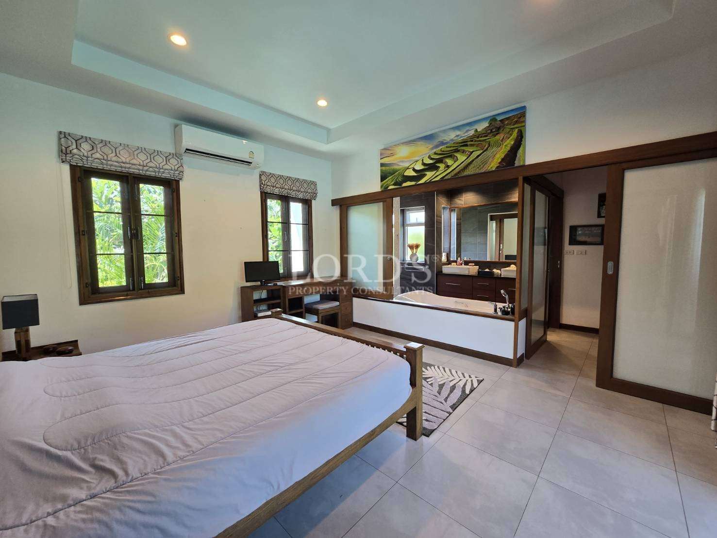 Bedroom with large bed and wooden decor