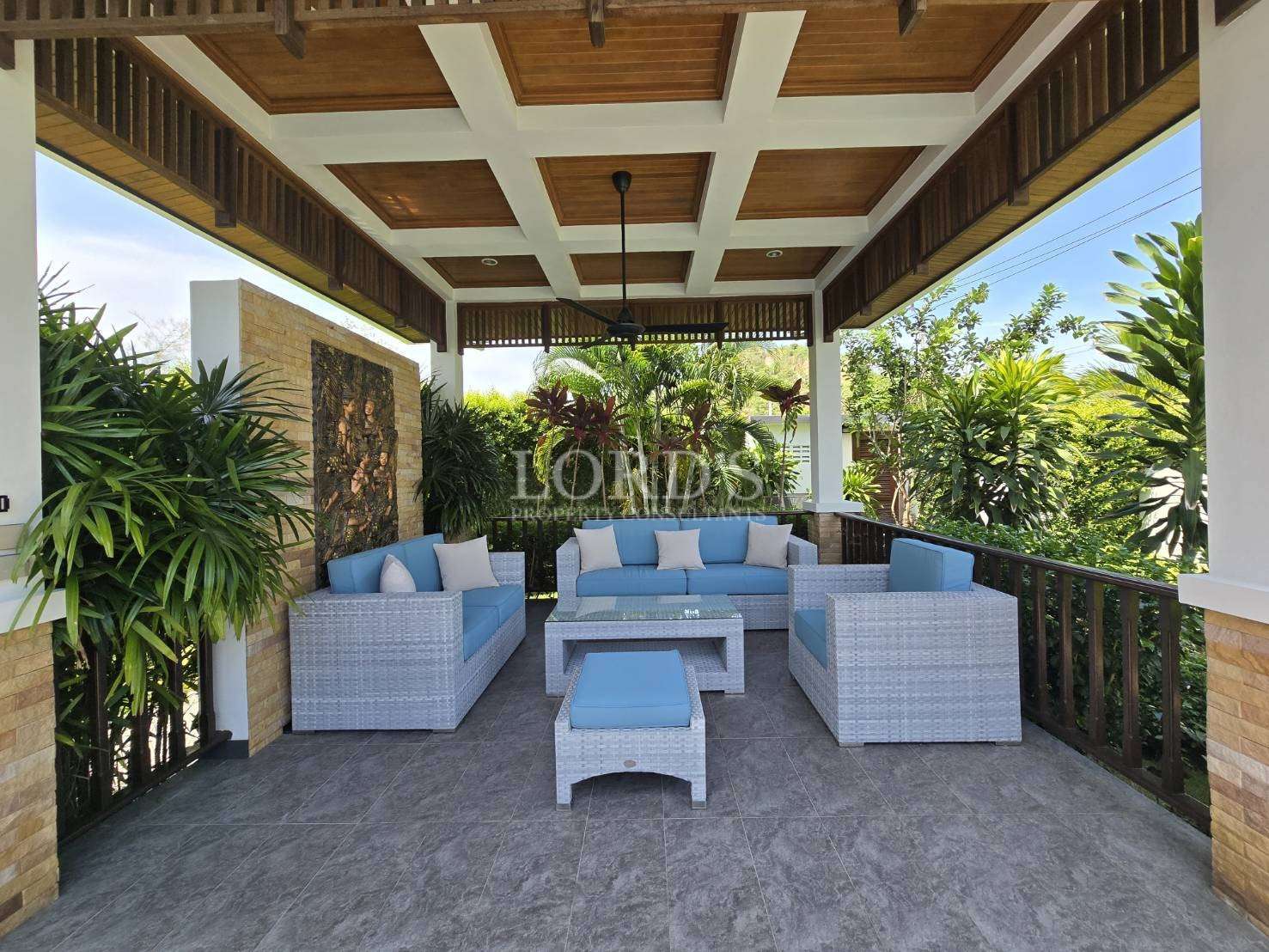 Outdoor lounge with sofa and greenery