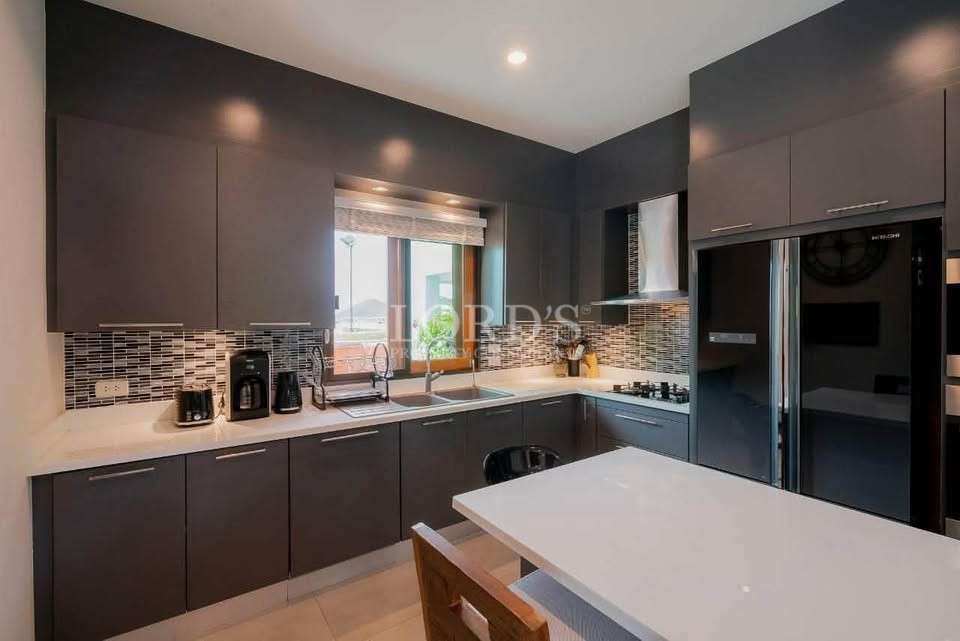 Kitchen with dark cabinets and lighting