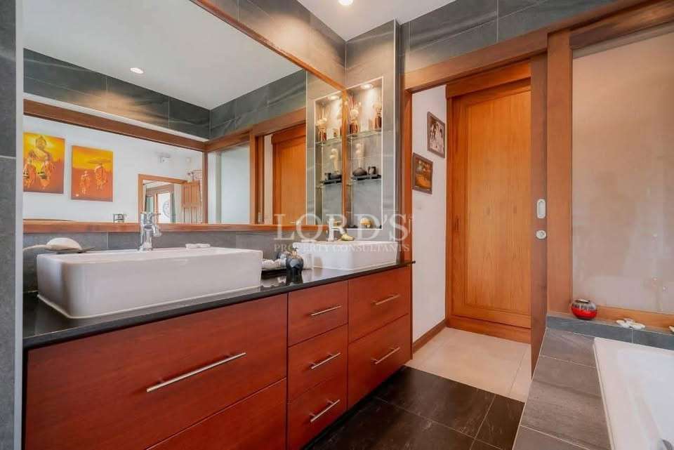Bathroom with wooden cabinet and sink