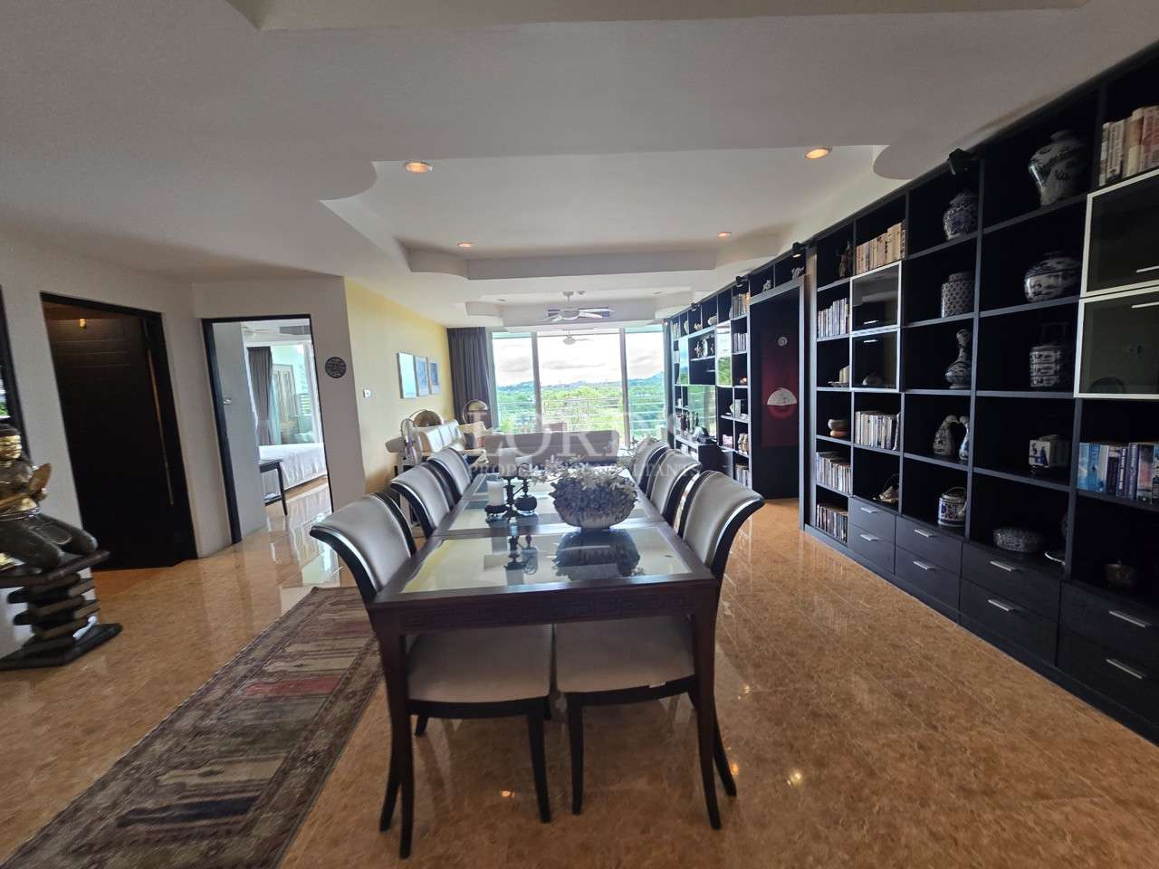 Spacious dining room with large table and built-in shelving.